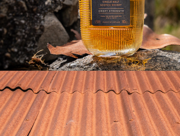 Bottle of Hearach whisky on a rustic surface with a natural background