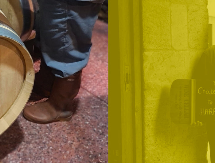 Close-up of a Château Biac wine cask alongside a person holding a sign indicating its delivery to Isle of Harris Distillery